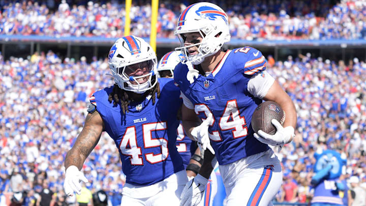 Buffalo Bills safety Cole Bishop and outside linebacker Shaq Thompson celebrate after intercepting a pass.