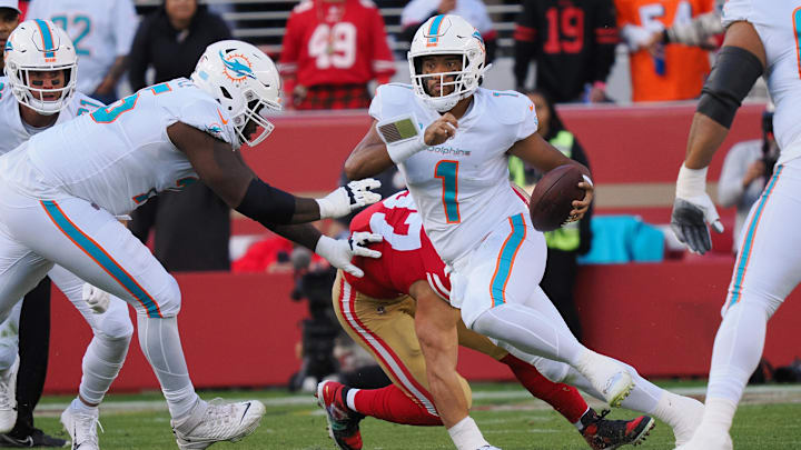 Miami Dolphins quarterback Tua Tagovailoa (1) escapes San Francisco 49ers defensive end Nick Bosa (97) during the first quarter at Levi's Stadium in 2022. Miami Dolphins quarterback Tua Tagovailoa (1) escapes San Francisco 49ers defensive end Nick Bosa (97) during the first quarter at Levi's Stadium in 2022.