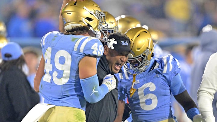 Nov 8, 2024; Pasadena, California, USA; UCLA Bruins defensive coordinator Ikaika Malloe, center, celebrates with linebacker Carson Schwesinger (49) defensive back Jaylin Davies (6) after an interception in the second half against the Iowa Hawkeyes at the Rose Bowl. Mandatory Credit: Jayne Kamin-Oncea-Imagn Images Nov 8, 2024; Pasadena, California, USA; UCLA Bruins defensive coordinator Ikaika Malloe, center, celebrates with linebacker Carson Schwesinger (49) defensive back Jaylin Davies (6) after an interception in the second half against the Iowa Hawkeyes at the Rose Bowl. Mandatory Credit: Jayne Kamin-Oncea-Imagn Images