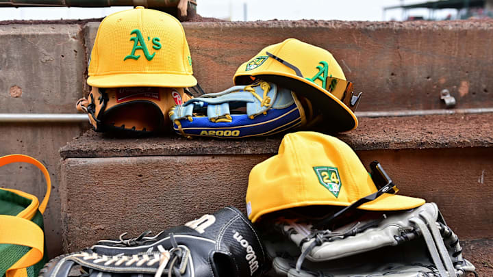 Mar 6, 2024; Tempe, Arizona, USA;  General view of Oakland Athletics hats and gloves prior to a spring training game against the Los Angeles Angels at Tempe Diablo Stadium. Mandatory Credit: Matt Kartozian-Imagn Images