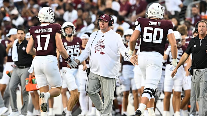 Aug 31, 2024; College Station, Texas, USA; Texas A&M Aggies head coach Mike Elko high fives players as they exit the field during the second quarter against the Notre Dame Fighting Irish at Kyle Field. Mandatory Credit: Maria Lysaker-Imagn Images