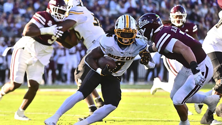 Nov 23, 2024; Starkville, Mississippi, USA; Missouri Tigers running back Nate Noel (8) runs against Mississippi State Bulldogs linebacker Stone Blanton (7) during the second quarter at Davis Wade Stadium at Scott Field. Mandatory Credit: Matt Bush-Imagn Images Nov 23, 2024; Starkville, Mississippi, USA; Missouri Tigers running back Nate Noel (8) runs against Mississippi State Bulldogs linebacker Stone Blanton (7) during the second quarter at Davis Wade Stadium at Scott Field. Mandatory Credit: Matt Bush-Imagn Images