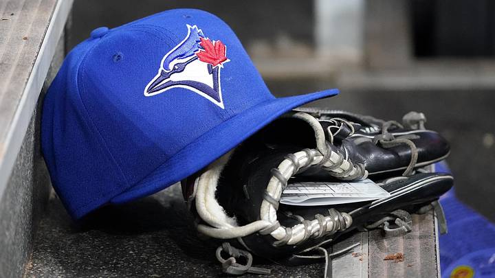 A Toronto Blue Jays hat and glove A Toronto Blue Jays hat and glove