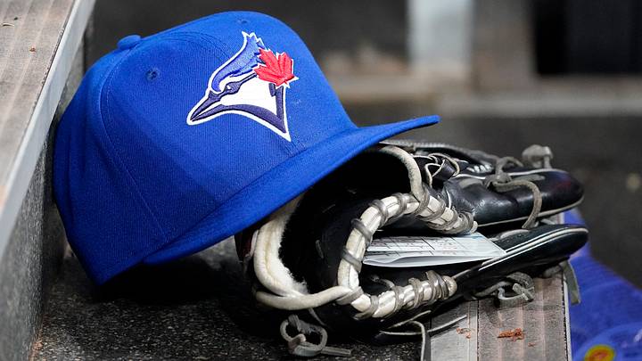 Toronto Blue Jays hat and glove in the dugout. Credit: John E. Sokolowski-Imagn Images Toronto Blue Jays hat and glove in the dugout. Credit: John E. Sokolowski-Imagn Images
