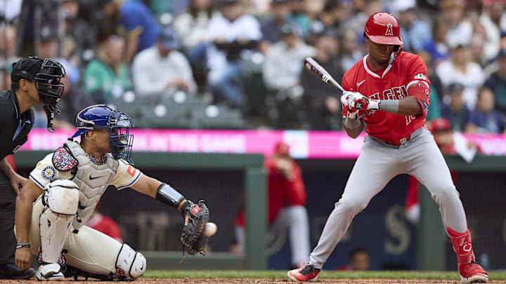 Sep 14, 2025; Seattle, Washington, USA; Seattle Mariners catcher Harry Ford (5) catches as Los Angeles Angels shortstop Denzer Guzman (13) bats during the eighth inning at T-Mobile Park. Mandatory Credit: John Froschauer-Imagn Images