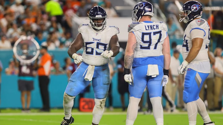 Sep 30, 2024; Miami Gardens, Florida, USA; Tennessee Titans defensive tackle Sebastian Joseph-Day (69) celebrates with defensive tackle James Lynch (97) after sacking Miami Dolphins quarterback Tyler Huntley (not pictured) during the third quarter at Hard Rock Stadium. Mandatory Credit: Sam Navarro-Imagn Images