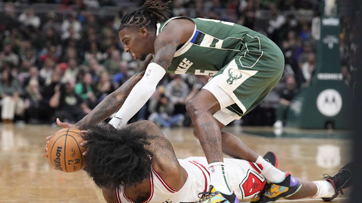Oct 25, 2024; Milwaukee, Wisconsin, USA; Milwaukee Bucks guard Delon Wright (55) battles for the ball with Chicago Bulls guard Coby White (0) in the first half at Fiserv Forum. Mandatory Credit: Michael McLoone-Imagn Images