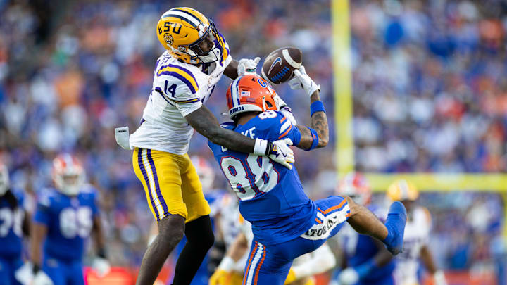 Nov 16, 2024; Gainesville, Florida, USA; LSU Tigers cornerback Zy Alexander (14) breaks up a pass to Florida Gators wide receiver Marcus Burke (88) during the first half at Ben Hill Griffin Stadium. Mandatory Credit: Matt Pendleton-Imagn Images