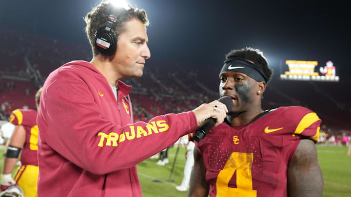 Oct 25, 2024; Los Angeles, California, USA; Jordan Moore interviews Southern California Trojans running back Woody Marks (4) after the game against the Rutgers Scarlet Knights at United Airlines Field at Los Angeles Memorial Coliseum.