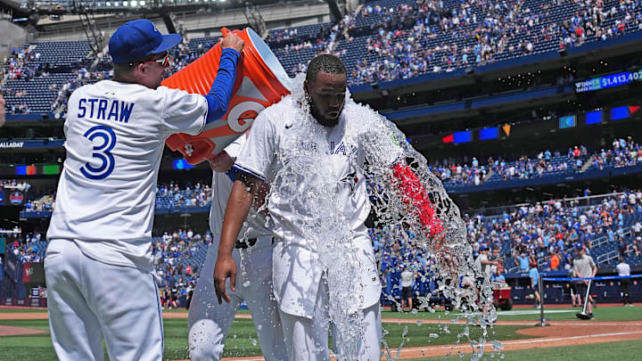 Jul 20, 2025; Toronto, Ontario, CAN; Toronto Blue Jays first baseman Vladimir Guerrero Jr. (27) gets the water bucket poured on him at the end of the ninth inning against the San Francisco Giants at Rogers Centre.