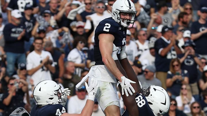 Penn State receiver Liam Clifford is lifted into the air by offensive lineman Anthony Donkoh (68) and tight end Tyler Warren after scoring a touchdown against Kent State. 