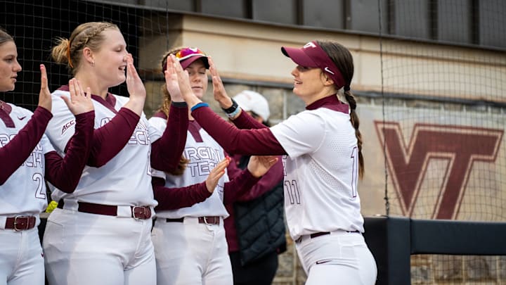 Kylie Aldridge (11) walks down the line of Hokie teammates giving them each high fives. Kylie Aldridge (11) walks down the line of Hokie teammates giving them each high fives.
