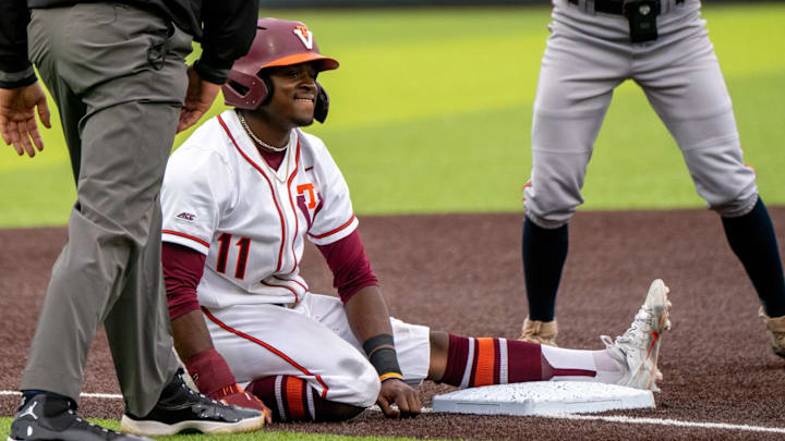 Jared Davis sits at third base after a close sliding play.