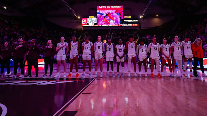 Virginia Tech Hokies Women's Basketball stands shoulder to shoulder for the national anthem. Virginia Tech Hokies Women's Basketball stands shoulder to shoulder for the national anthem.