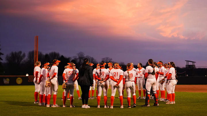 The Hokies gather in left field underneath the sunset after their Friday victory over NC State. 