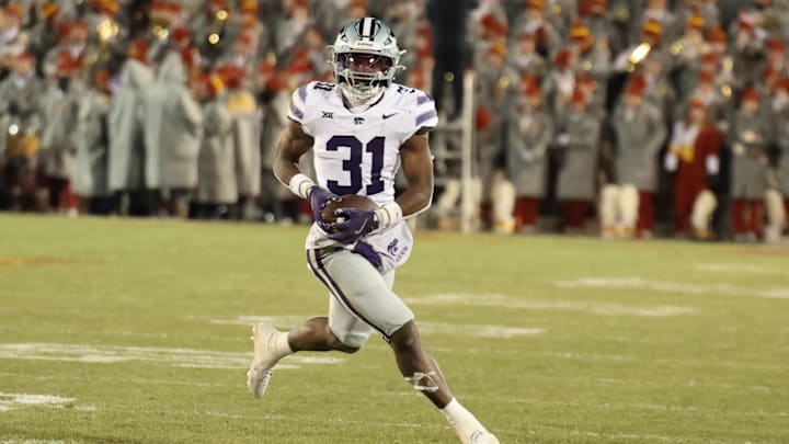 Nov 30, 2024; Ames, Iowa, USA; Kansas State Wildcats running back DJ Giddens (31) runs for a first down against the Iowa State Cyclones in the second quarter at at Jack Trice Stadium. Mandatory Credit: Reese Strickland-Imagn Images