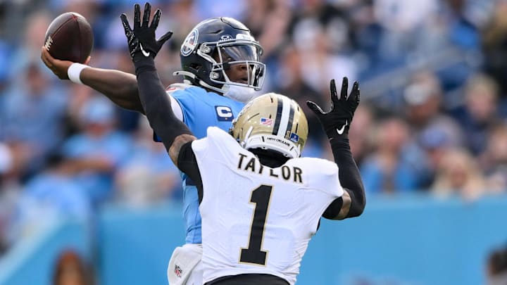 Dec 28, 2025; Nashville, Tennessee, USA;  New Orleans Saints cornerback Alontae Taylor (1) hits Tennessee Titans quarterback Cameron Ward (1) as he throws a pass during the second half at Nissan Stadium. Mandatory Credit: Steve Roberts-Imagn Images