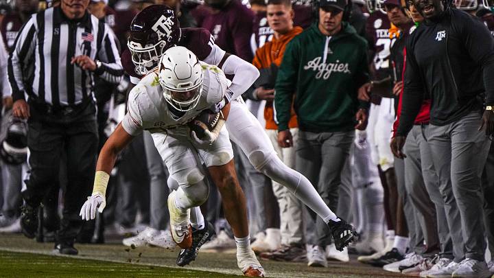 Texas Longhorns tight end Gunnar Helm (85) is tackled by Texas A&M defensive back Dezz Ricks (10) during the Lone Star Showdown at Kyle Field. Texas Longhorns tight end Gunnar Helm (85) is tackled by Texas A&M defensive back Dezz Ricks (10) during the Lone Star Showdown at Kyle Field.