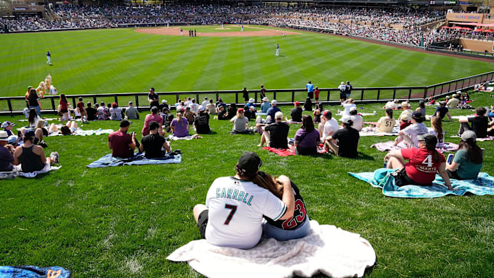Fans watch the action from the left field lawn as the Arizona Diamondbacks play the Colorado Rockies during the first spring training game at Salt River Fields on Feb. 23, 2024.