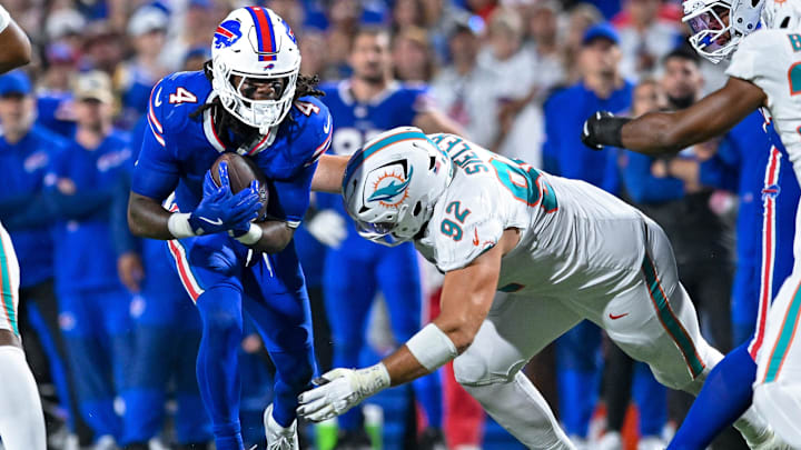 Buffalo Bills running back James Cook (4) is tackled by Miami Dolphins defensive tackle Zach Sieler (92) in the fourth quarter at Highmark Stadium. 