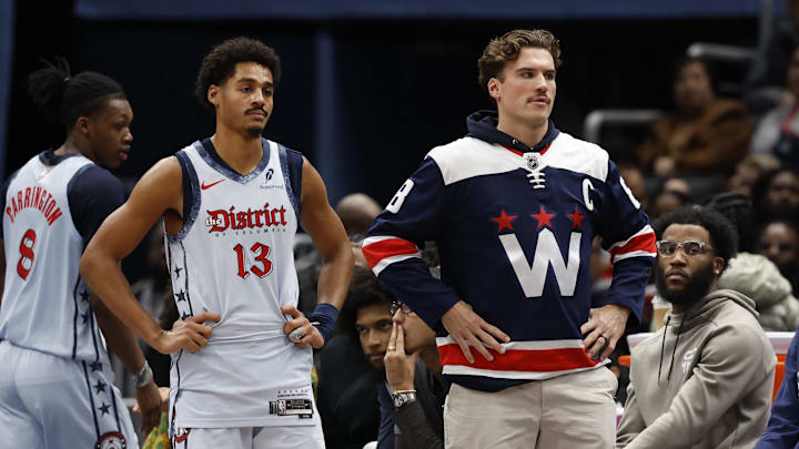 Dec 8, 2024; Washington, District of Columbia, USA; Washington Wizards guard Jordan Poole (13) and injured Wizards forward Corey Kispert (R) look on from the bench against the Memphis Grizzlies in the third quarter at Capital One Arena. Mandatory Credit: Geoff Burke-Imagn Images