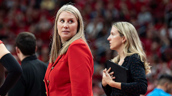 Louisville head coach Dani Busboom Kelly looked over at her bench during a timeout as the No. 3 Louisville Cardinals women's volleyball team faced off against the No. 1 Pitt Panthers on Wednesday, Nov. 27, 2024.