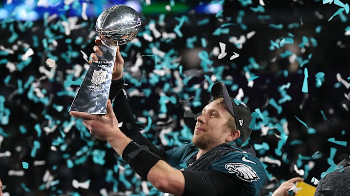 Feb 4, 2018; Minneapolis, MN, USA; Philadelphia Eagles quarterback Nick Foles (9) hoist the Vince Lombardi Trophy after a victory against the New England Patriots in Super Bowl LII at U.S. Bank Stadium. Mandatory Credit: Matthew Emmons-Imagn Images