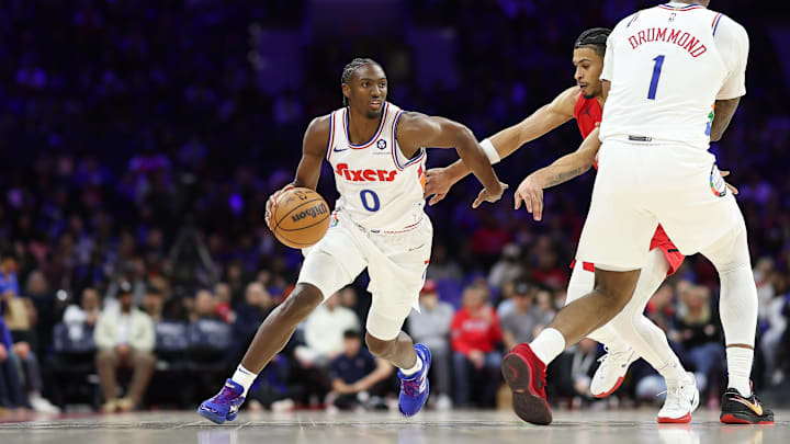 Mar 3, 2025; Philadelphia, Pennsylvania, USA; Philadelphia 76ers guard Tyrese Maxey (0) dribbles past Portland Trail Blazers forward Toumani Camara (33) during the first quarter at Wells Fargo Center. Mandatory Credit: Bill Streicher-Imagn Images