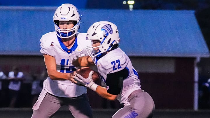 Mukwonago running back Mason Radobicky (22) takes a hand-off from quarterback Mason Kelley (13) during the game at Muskego on Friday, Sept. 13, 2024.
