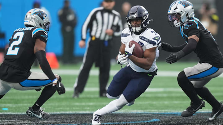 Dec 28, 2025; Charlotte, North Carolina, USA; Seattle Seahawks running back Kenneth Walker III (9) runs the ball against Carolina Panthers cornerback Mike Jackson (2) during the second quarter at Bank of America Stadium. Mandatory Credit: Jim Dedmon-Imagn Images