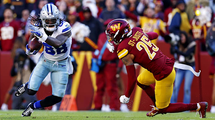 Nov 24, 2024; Landover, Maryland, USA; Dallas Cowboys wide receiver CeeDee Lamb (88) runs the ball after a catch against Washington Commanders cornerback Benjamin St-Juste (25) during the second quarter at Northwest Stadium.  