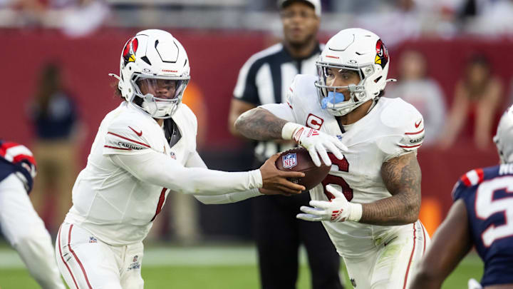 Dec 15, 2024; Glendale, Arizona, USA; Arizona Cardinals quarterback Kyler Murray (1) hands off the ball to running back James Conner (6) against the New England Patriots at State Farm Stadium. Mandatory Credit: Mark J. Rebilas-Imagn Images