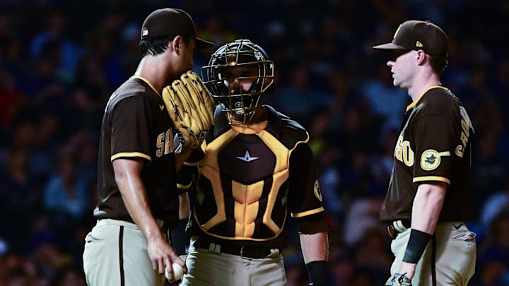 Austin Nola (26), Jake Cronenworth (9) and San Diego Padres starting pitcher Yu Darvish (11) discuss on the mound in the fifth inning at Wrigley Field. 