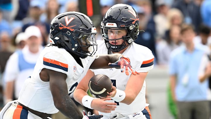 Oct 25, 2025; Chapel Hill, North Carolina, USA;  Virginia Cavaliers quarterback Chandler Morris (4) hands the ball off to wide receiver Andre Greene Jr. (2) in the third quarter at Kenan Stadium. Mandatory Credit: Bob Donnan-Imagn Images