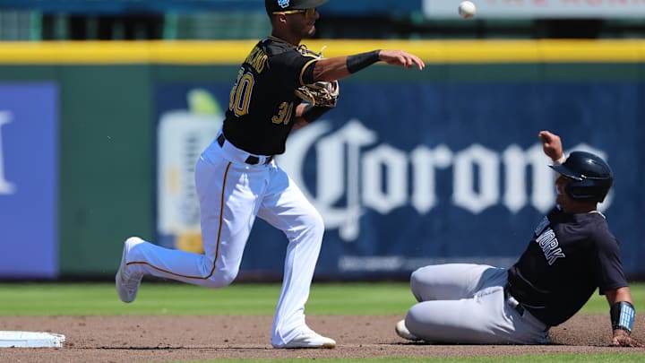 Pirates infielder Tucupita Marcano (30) forces out New York Yankees catcher Rodolfo  Duran (96) and throws the ball to first base in the third inning at LECOM Park on March 11, 2023.