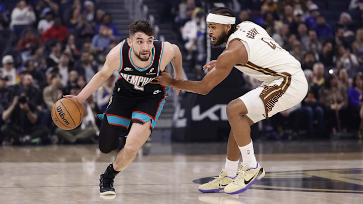 Feb 9, 2026; San Francisco, California, USA; Memphis Grizzlies guard Ty Jerome (2) controls the ball against Golden State Warriors guard Moses Moody (4) during the first quarter at Chase Center. Mandatory Credit: Kelley L Cox-Imagn Images