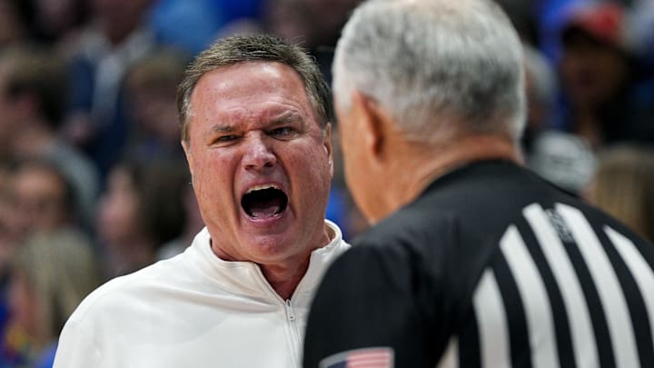 Dec 31, 2024; Lawrence, Kansas, USA; Kansas Jayhawks head coach Bill Self talks to official Randy McCall during the second half against the West Virginia Mountaineers at Allen Fieldhouse. Mandatory Credit: Jay Biggerstaff-Imagn Images