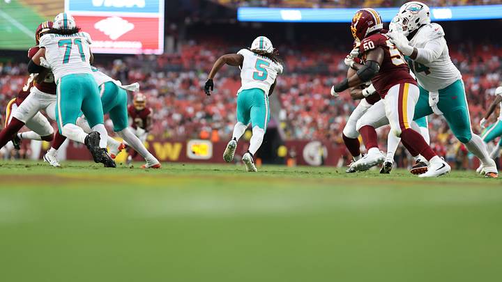 iami Dolphins running back Jaylen Wright (5) carries the ball past Washington Commanders defensive tackle Ricky Barber (50) during the first half at Northwest Stadium. iami Dolphins running back Jaylen Wright (5) carries the ball past Washington Commanders defensive tackle Ricky Barber (50) during the first half at Northwest Stadium.