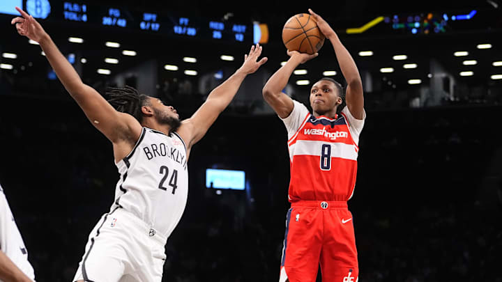 Oct 14, 2024; Brooklyn, New York, USA; Washington Wizards guard Bub Carrington (8) shoots a jump shot over Brooklyn Nets small guard Cam Thomas (24) during the second half at Barclays Center. Mandatory Credit: Gregory Fisher-Imagn Images