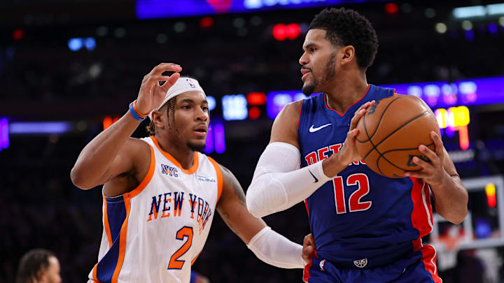 Dec 7, 2024; New York, New York, USA; Detroit Pistons forward Tobias Harris (12) is guarded by New York Knicks guard Miles McBride (2) during the first half at Madison Square Garden. Mandatory Credit: Vincent Carchietta-Imagn Images