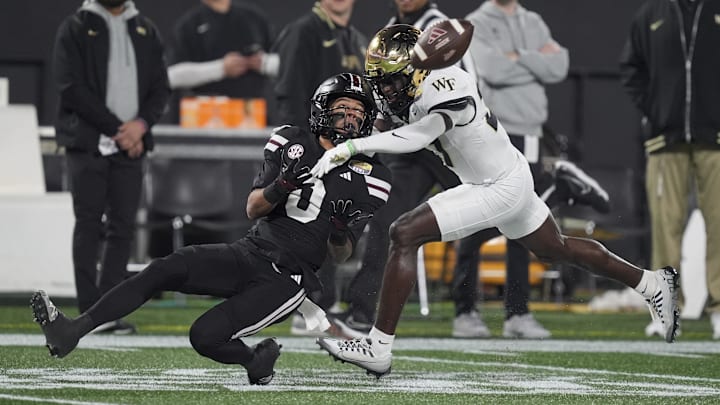 Jan 2, 2026; Charlotte, NC, USA; Mississippi State Bulldogs wide receiver Brenen Thompson (0) makes a opening play catch defended by Wake Forest Demon Deacons defensive back Karon Prunty (3) during the first quarter at Bank of America Stadium. Mandatory Credit: Jim Dedmon-Imagn Images