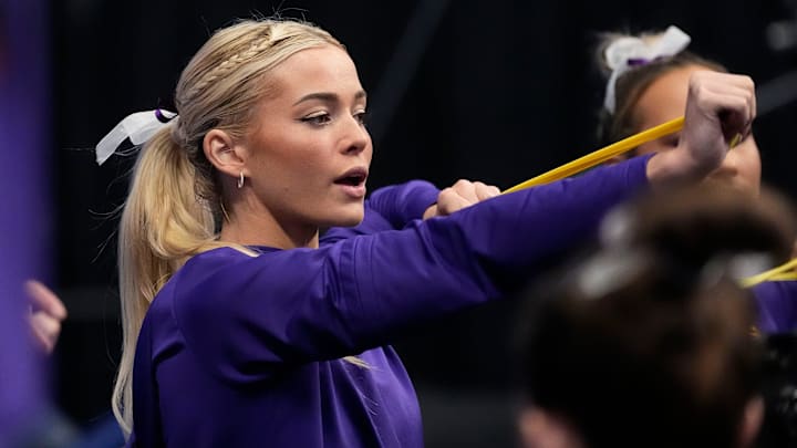 LSU gymnast Livvy Dunne stretches with teammates before Session 2 of the SEC Gymnastics Tournament at Legacy Arena in Birmingham, Alabama.