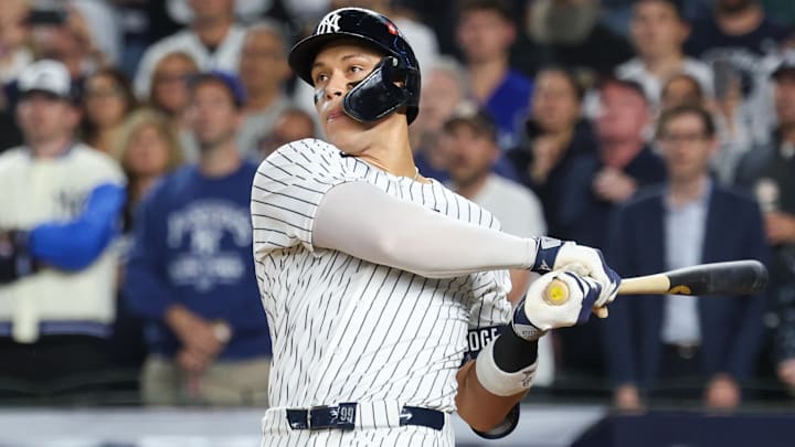 Oct 7, 2025; Bronx, New York, USA; New York Yankees outfielder Aaron Judge (99) hits a three-run home run in the fourth inning against the Toronto Blue Jays during game three of the ALDS round for the 2025 MLB playoffs at Yankee Stadium. Mandatory Credit: Vincent Carchietta-Imagn Images