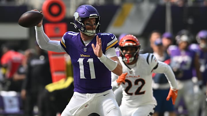Sep 21, 2025; Minneapolis, Minnesota, USA; Minnesota Vikings quarterback Carson Wentz (11) throws downfield against the Cincinnati Bengals during the first half at U.S. Bank Stadium.