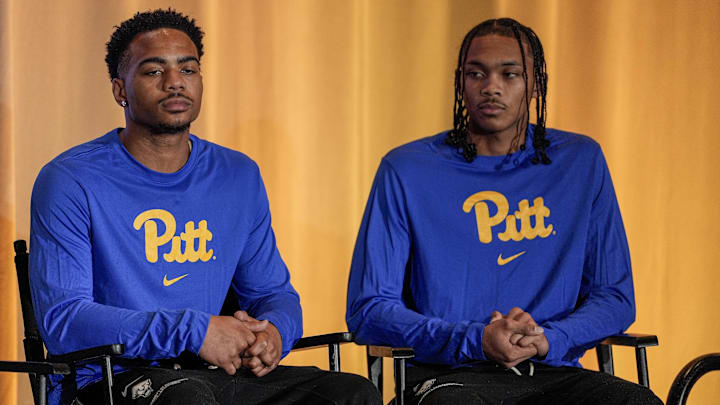 Oct 10, 2024; Charlotte, NC, USA; Pittsburgh player Jaland Lowe and  Ishmael Leggett listen to their coach answer questions from the media at The Hilton Charlotte Uptown. Mandatory Credit: Jim Dedmon-Imagn Images