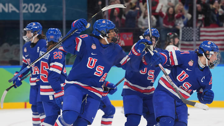 Feb 19, 2026; Milan, Italy; Hilary Knight (21) of the United States is hugged by teammates after scoring a goal against Canada in the women's ice hockey gold medal game during the Milano Cortina 2026 Olympic Winter Games at Milano Santagiulia Ice Hockey Arena. Mandatory Credit: Amber Searls-Imagn Images Feb 19, 2026; Milan, Italy; Hilary Knight (21) of the United States is hugged by teammates after scoring a goal against Canada in the women's ice hockey gold medal game during the Milano Cortina 2026 Olympic Winter Games at Milano Santagiulia Ice Hockey Arena. Mandatory Credit: Amber Searls-Imagn Images