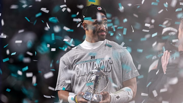Jan 26, 2025; Philadelphia, PA, USA; Philadelphia Eagles quarterback Jalen Hurts (1) holds the NFC Championship trophy after a victory in the NFC Championship game against the Washington Commanders at Lincoln Financial Field. Mandatory Credit: Bill Streicher-Imagn Images