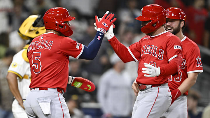May 12, 2025; San Diego, California, USA; Los Angeles Angels left fielder Taylor Ward (3), right, is congratulated by Yoan Moncada (5) after hitting a grand slam during the ninth inning against the San Diego Padres at Petco Park. Mandatory Credit: Denis Poroy-Imagn Images