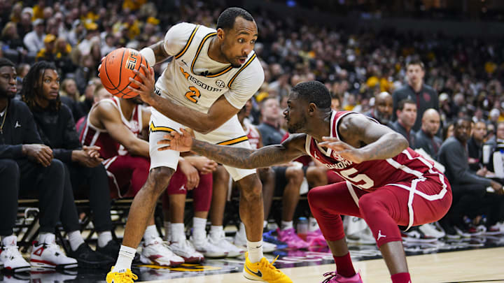 Feb 12, 2025; Columbia, Missouri, USA; Missouri Tigers guard Tamar Bates (2) looks to drive against Oklahoma Sooners guard Duke Miles (15) during the first half at Mizzou Arena. Mandatory Credit: Jay Biggerstaff-Imagn Images