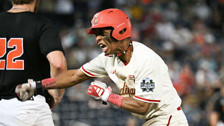 Jun 13, 2025; Omaha, Neb, USA; Louisville Cardinals second baseman Kamau Neighbors (5) signals the bench after driving in a run with a single against the Oregon State Beavers during the ninth inning at Charles Schwab Field. Mandatory Credit: Steven Branscombe-Imagn Images
